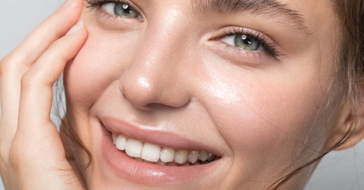 Close up studio shot of a beautiful woman with perfect skin, she touching her face Screenshot